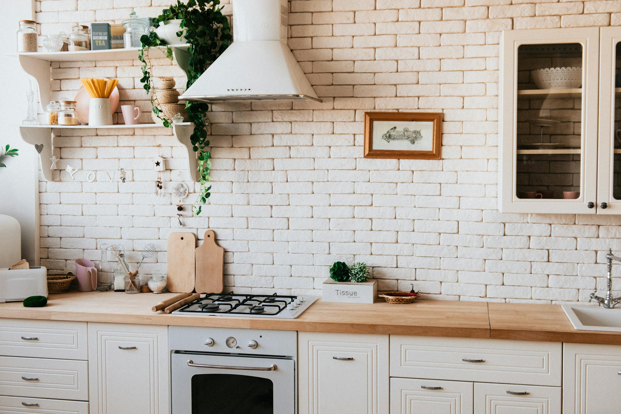 Stylish kitchen interior with modern appliances, wooden counters, and greenery accents.