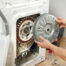 repairman replacing a cylinder on a dryer