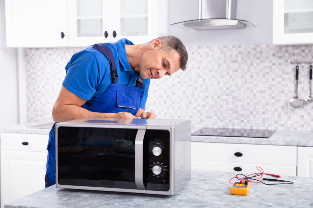 repairman fixing a microwave