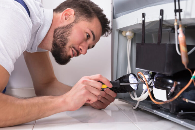 repairman fixing refrigerator