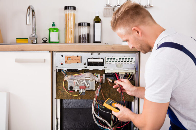 repairman working on a dishwasher