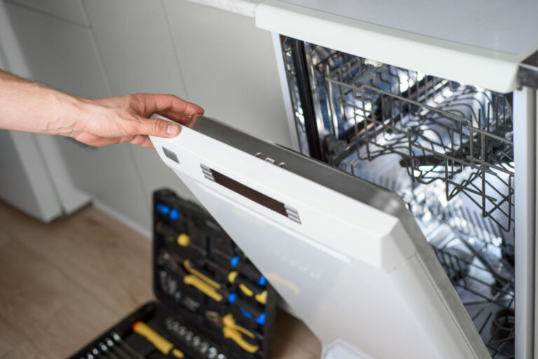 repairman working on a dishwasher